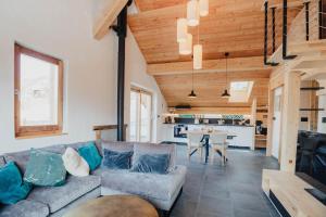 a living room with a couch and a table at Mountain Escape Briançon views in Villar-Saint-Pancrace