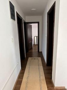 a hallway with several doors and a rug on the floor at Vila Sekulić in Podgorica