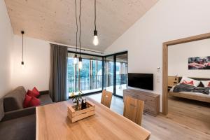 a living room with a table and a couch at Ölackererhof in Bressanone