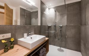 a bathroom with a sink and a shower at Ölackererhof in Bressanone