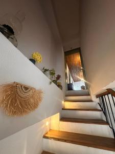 a set of stairs with a window and a window at Kidoni Macaron Guesthouse in Ayvalık