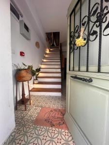 a hallway with a staircase with a rug on the floor at Kidoni Macaron Guesthouse in Ayvalık
