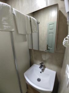 a bathroom with a sink and a mirror at Kidoni Macaron Guesthouse in Ayvalık +28 photos