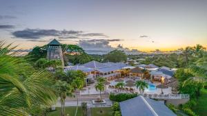 eine Luftansicht eines Resorts mit Pool und Turm in der Unterkunft Le Relais du Moulin - Hôtel de Charme & Spa Adult Only in Sainte-Anne