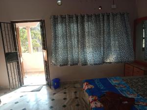 a bedroom with a bed and a sliding glass door at Devka villa in Daman