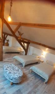 a room with two beds in a attic at Sous Le Même Toit in Rendeux