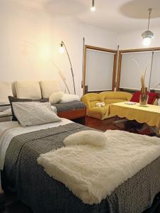 a bedroom with a bed and a living room at Oporto Central Flat in Porto