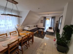 a living room with a table and a couch at Apartmenthaus Çelik Bielefeld Süd Senne in Bielefeld