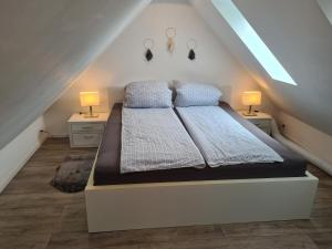 a bedroom with a large bed with two night stands at Apartmenthaus Çelik Bielefeld Süd Senne in Bielefeld