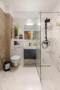 a bathroom with a toilet and a glass shower at Imperial HOME in Sibiu