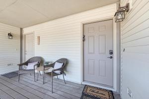 a porch with two chairs and a door at 5 Mi to Strip! Pointe Royale Condo w/ Indoor Pool in Branson +28 photos