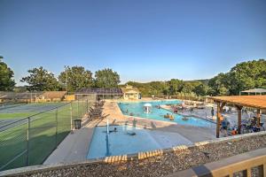 a pool with a tennis court and people in it at 5 Mi to Strip! Pointe Royale Condo w/ Indoor Pool in Branson