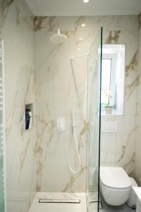 a bathroom with a shower and a toilet at Keratea Luxury Villa -Athens Airport in Keratea +42 photos