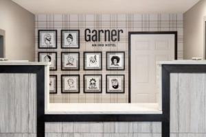 a room with framed pictures on a wall at Garner Hotel Clarksville Northeast, an IHG Hotel in Clarksville