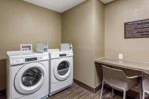 a laundry room with a washing machine and a counter at Garner Hotel Clarksville Northeast, an IHG Hotel in Clarksville