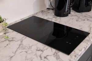 a counter top with a black microwave on it at Modern Spacious Central Studio in Manchester