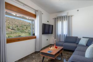 a living room with a couch and a table at Seacret House Sifnos in Faros