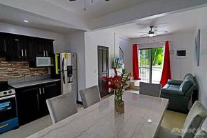 a kitchen and dining room with a table and chairs at 2-BD Unit with Pool 2 Blocks from Beach in Coco