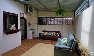 a living room with a couch and a window at 2-BD Unit with Pool 2 Blocks from Beach in Coco
