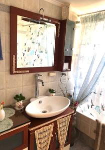 a bathroom with a sink and a window at Villa Dani in Aigio