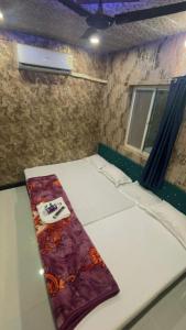 a room with a bed with a napkin on it at sun guest house 2 in Ujjain