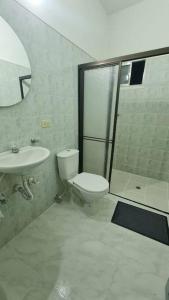 a bathroom with a toilet and a sink and a shower at Medellín Casa central Envigado frontera poblado in Envigado
