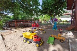 a group of toys in the sand in a sandbox at Baris Pension & Bungalows in Cıralı