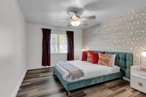 a bedroom with a bed and a ceiling fan at 10min to EXPO - Family-Friendly with Office & Playroom in Tulsa