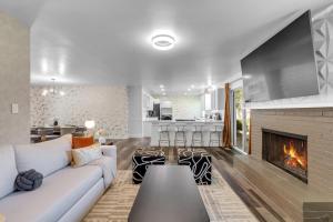 a living room with a couch and a fireplace at 10min to EXPO - Family-Friendly with Office & Playroom in Tulsa