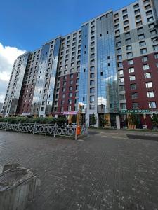 a large building with a fence in front of it at 1-комнатная возле Посольства США и Мечети Хазрет Султан in Astana