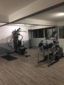 a gym with two treadmills and two exercise bikes at REVE BLEU in Le Diamant