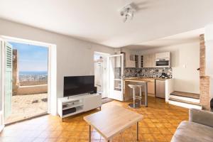 a living room with a television and a table at Barri furnished flat in Cagnes-sur-Mer