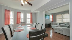 a dining room and living room with a table and chairs at Escape to Raleigh Ave 3 Steps from the Beach in Atlantic City