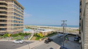 a view of a parking lot with a building and the beach at Escape to Raleigh Ave 3 Steps from the Beach in Atlantic City