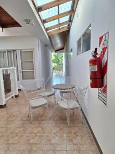 a room with a table and chairs and a fire hydrant at Departamentos MR in Villa Elisa