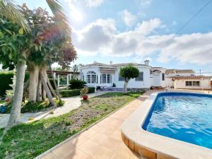 a villa with a swimming pool in front of a house at Charming Villa With Own Pool Urb La Siesta in La Mata