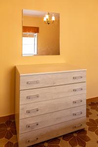 a dresser in a room with a mirror at Rifugio dell'Amore e Pace in Magliano Vetere