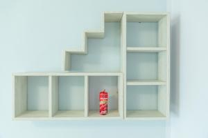 a white book shelf with a red box on it at Rifugio dell'Amore e Pace in Magliano Vetere