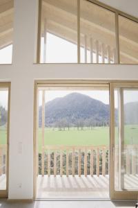 a large window in a house with a view of a field at Bergblick Chalet in Bayrischzell