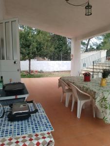 un patio avec une table, des chaises et un grill dans l'établissement Casa Refugio Entre Pinos y Romeros, à Mogente