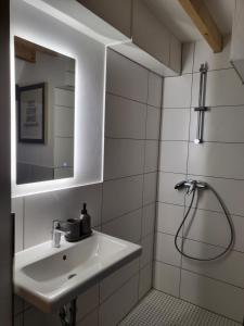a white bathroom with a sink and a shower at Ferienwohnung im Rebstock Nr.1 in Bahlingen +29 photos