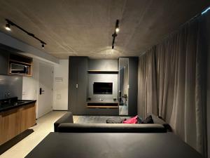 a living room with a couch and a television at Flat Frei Caneca in Sao Paulo