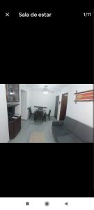 a picture of a room with a table and chairs at Apartamento no Centro de Ubatuba in Ubatuba