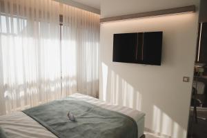 a bedroom with a bed and a flat screen tv at Hotel Bernarda in Varaždinske Toplice