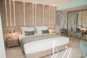 a bedroom with a large bed and a table and chairs at Hotel Bernarda in Varaždinske Toplice
