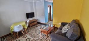 a living room with a couch and a table at Ganado26 in Sanlúcar de Barrameda