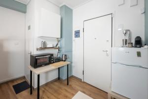 a kitchen with a small table and a refrigerator at Downtown Athens Studio in Athens