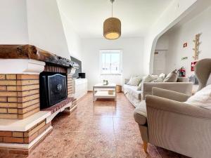a living room with a couch and a fireplace at Maty's place in Mafra