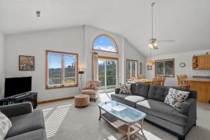 a living room with a couch and a table at 4670 - Shell-Y-Bration by Resort Realty in Southern Shores