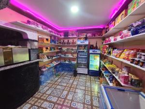 a grocery store with purple lights on the walls at Auberge le Refuge in Agadir